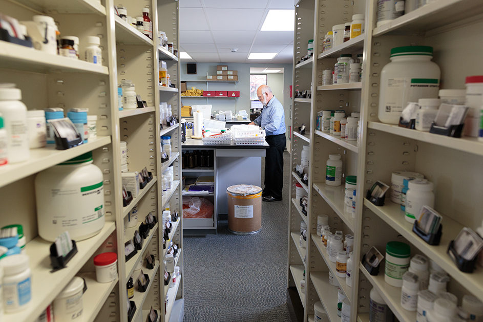 phar052218_033 A look inside the Pet Apothecary at prescriptions on shelves and staff member at counter