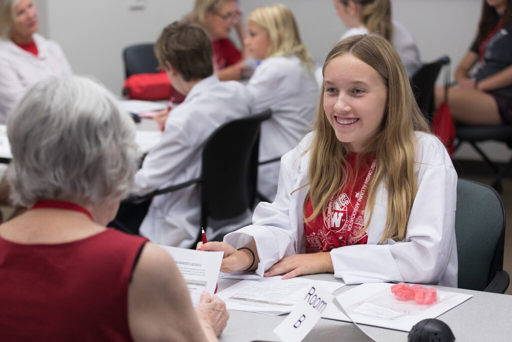 SoP Grandparents University 2023 A younger attendee smiles at an older attendee