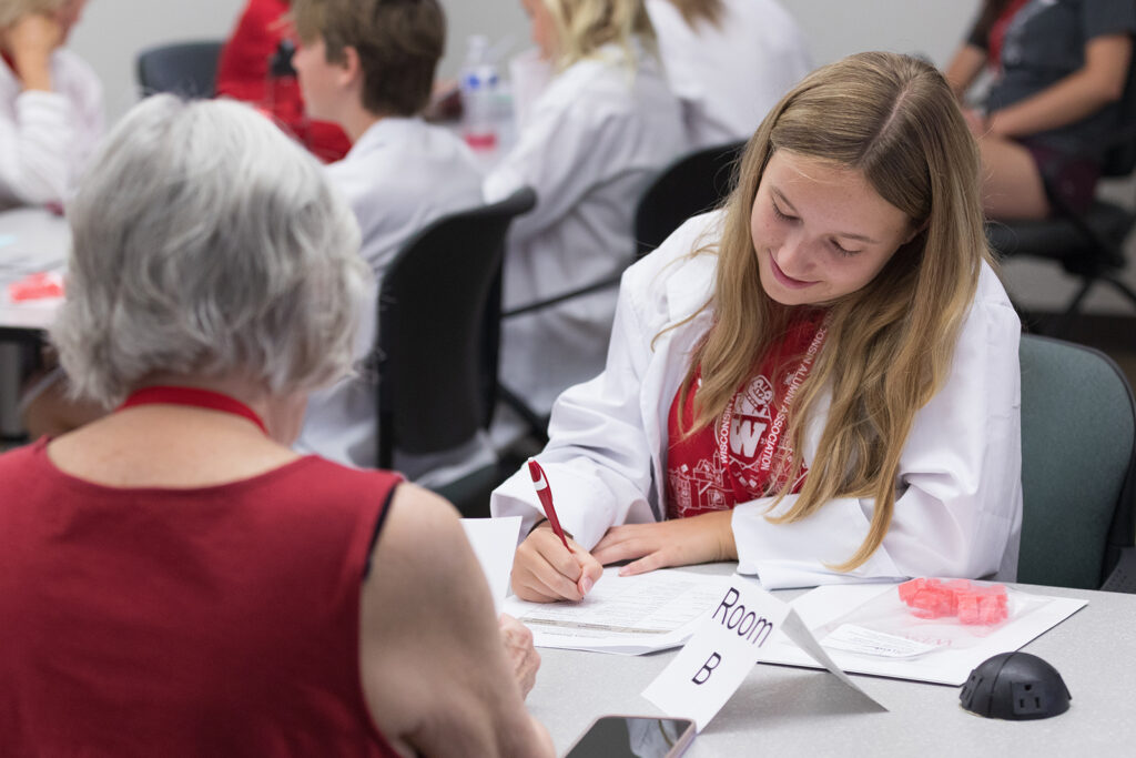 SoP Grandparents University 2023 A younger attendee fills out a worksheet