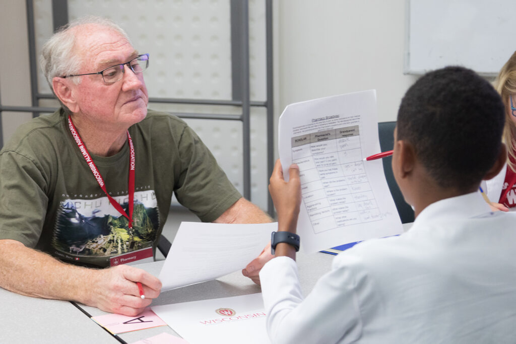SoP Grandparents University 2023 Attendees review papers at a table