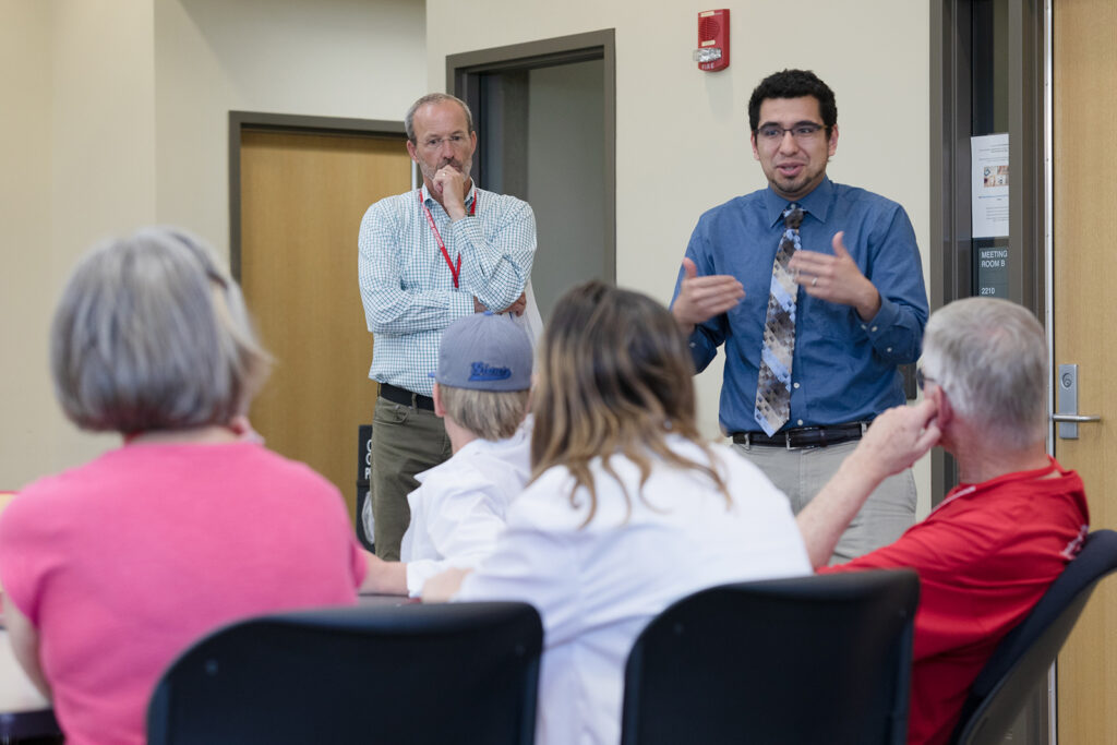 SoP Grandparents University 2023 Dave Mott listens in while Ed Portillo speaks to a table of attendees