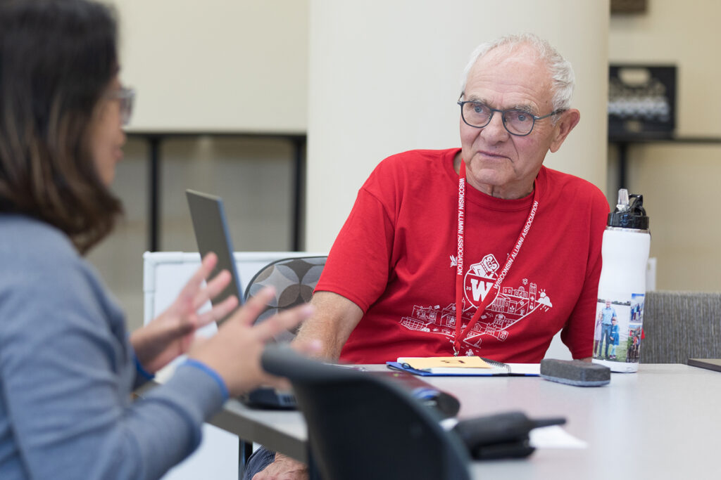 SoP Grandparents University 2023 An older attendee looks on as a younger attendee speaks