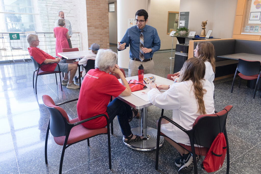 SoP Grandparents University 2023 Ed Portillo speaks with a table of attendees