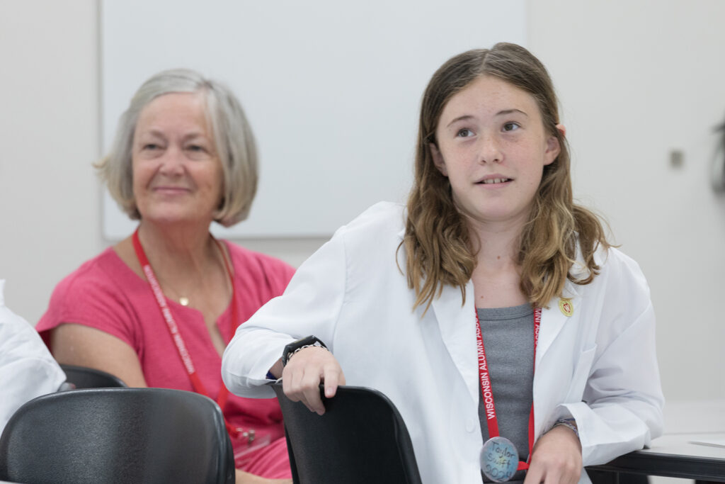 SoP Grandparents University 2023 A young attendee with an older attendee, listening to a presenter