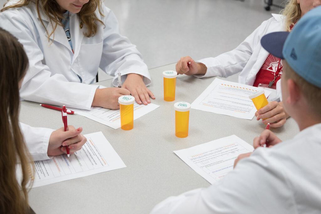 SoP Grandparents University 2023 An attendee fills out a worksheet about medication consultations