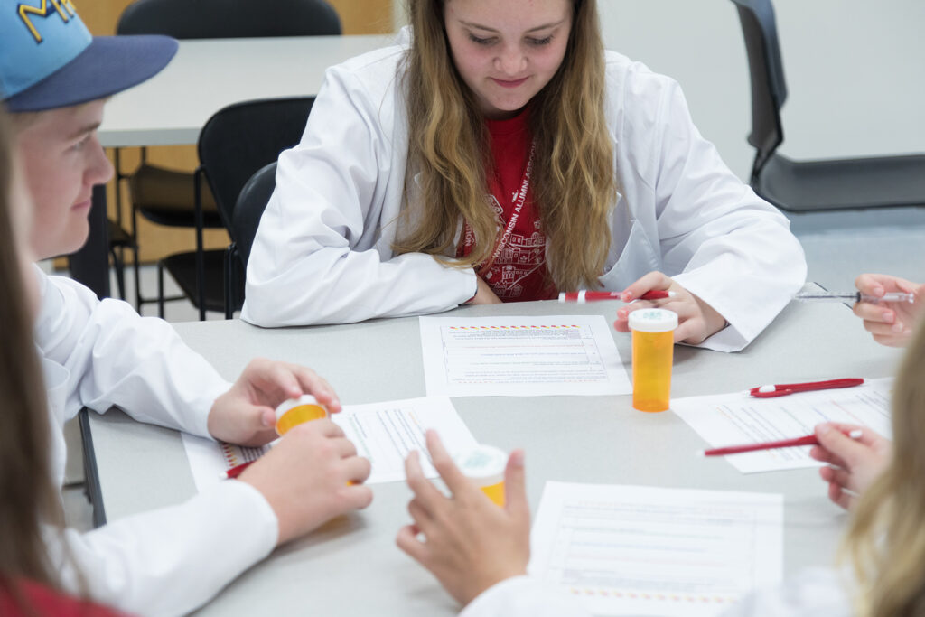 SoP Grandparents University 2023 An attendee fills out a worksheet about medication consultations