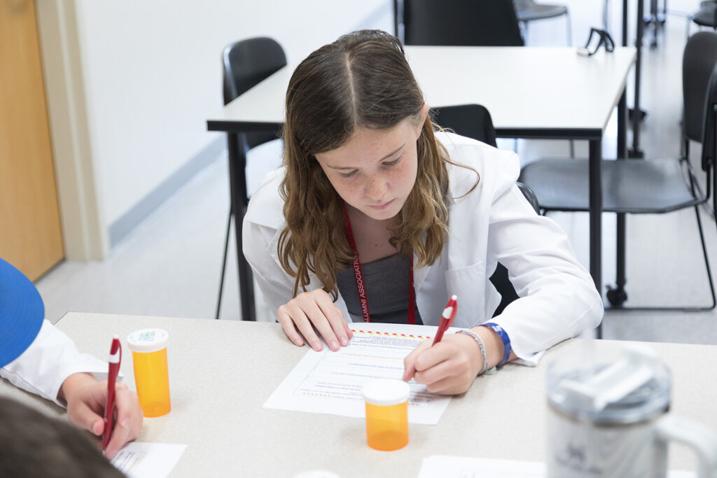 SoP Grandparents University 2023 An attendee fills out a worksheet about medication consultations