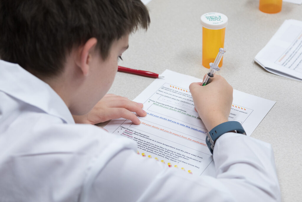 SoP Grandparents University 2023 An attendee fills out a worksheet about medication consultations