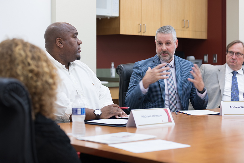 Chancellor Mnookin talking with staff in a conference room