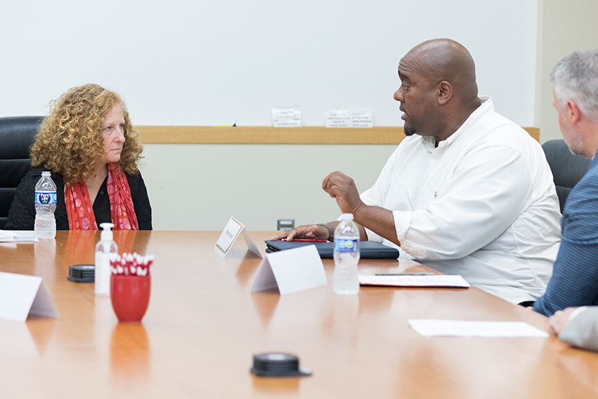 Chancellor Mnookin talking with staff in a conference room