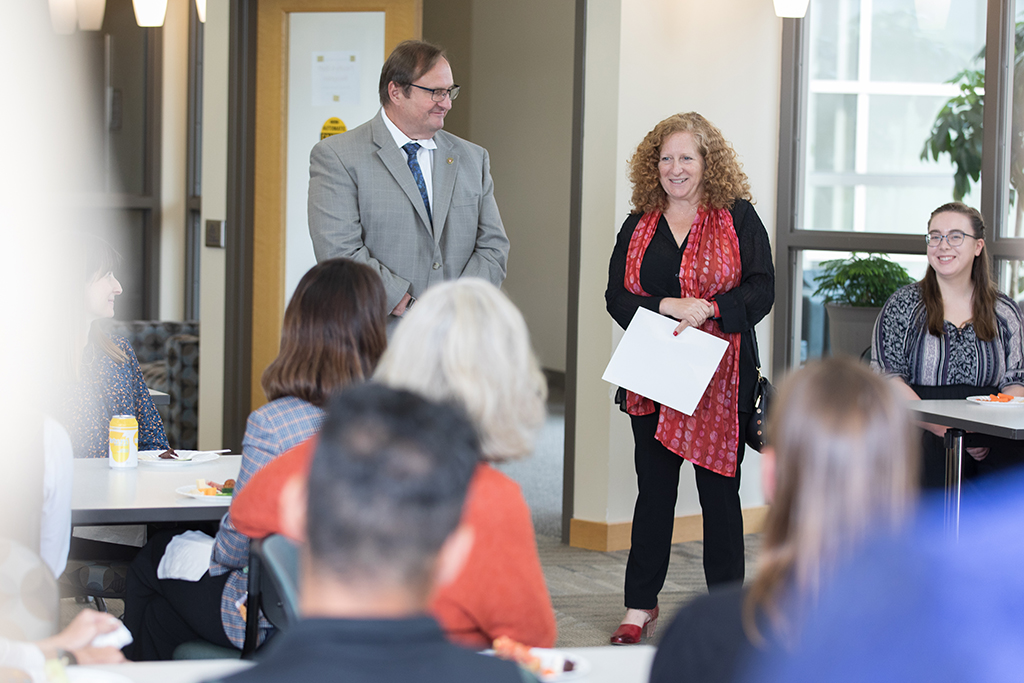 Chancellor Mnookin standing with SoP Dean Steve Swanson and speaking to a room of SoP faculty