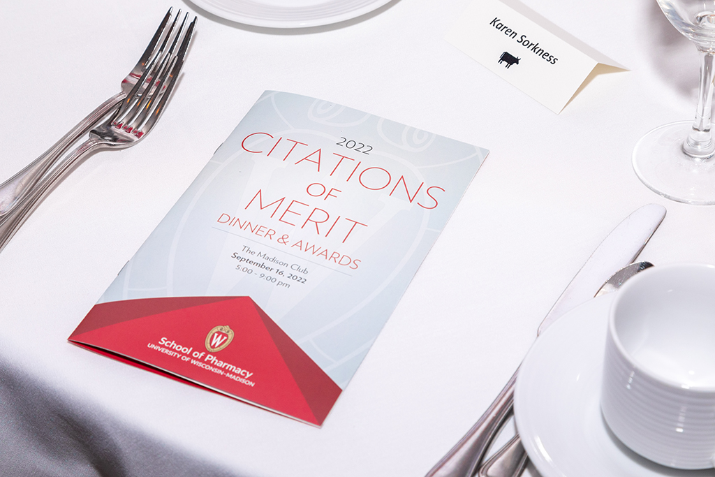 UW School of Pharmacy 2022 Citations of Merit Dinner & Awards A Citations of Merit program sits on a table.