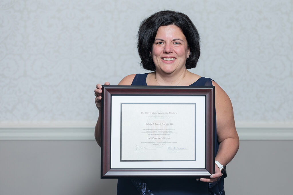 Michelle Farrell holds her Citation of Merit award.