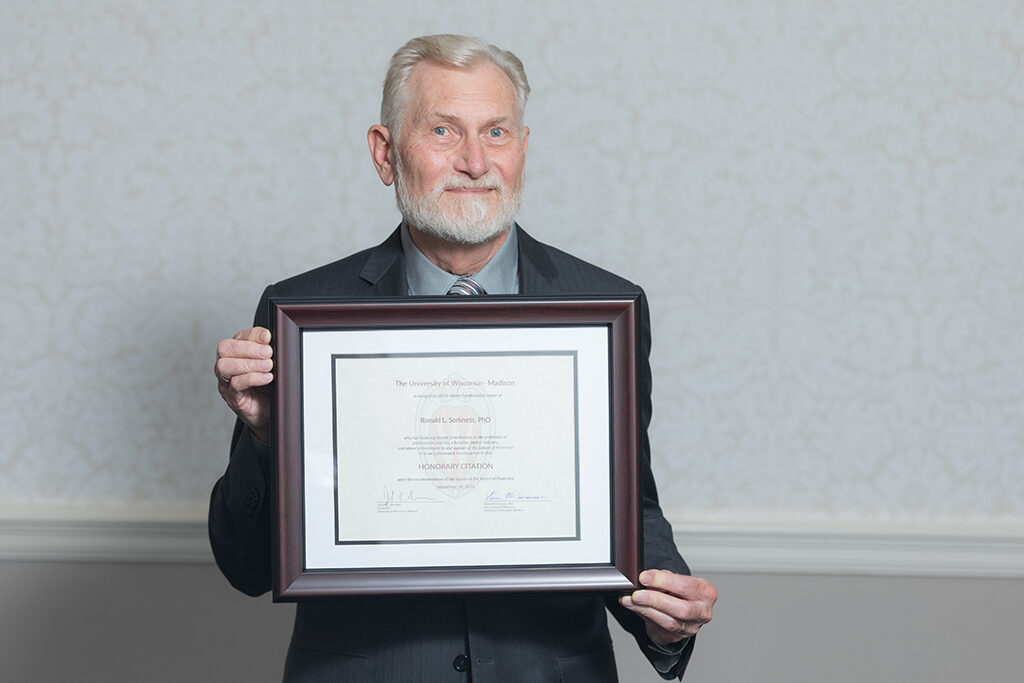 Ron Sorkness holding his Citation of Merit.