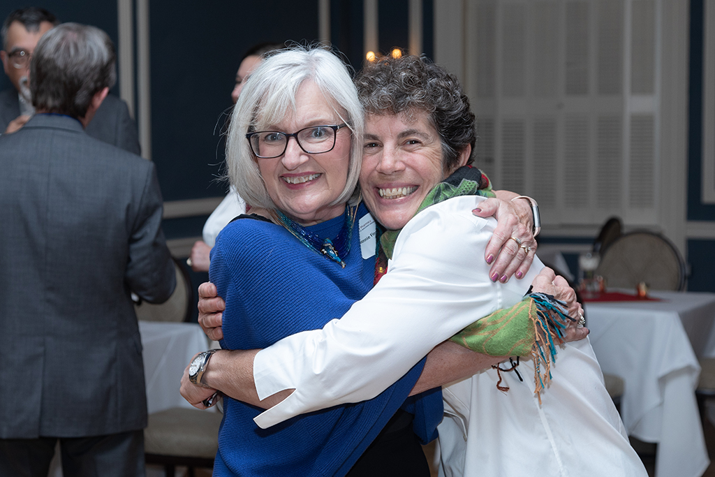 UW School of Pharmacy 2022 Citations of Merit Dinner & Awards Bonnie Fingerhut and Susan Stein hug and smile.