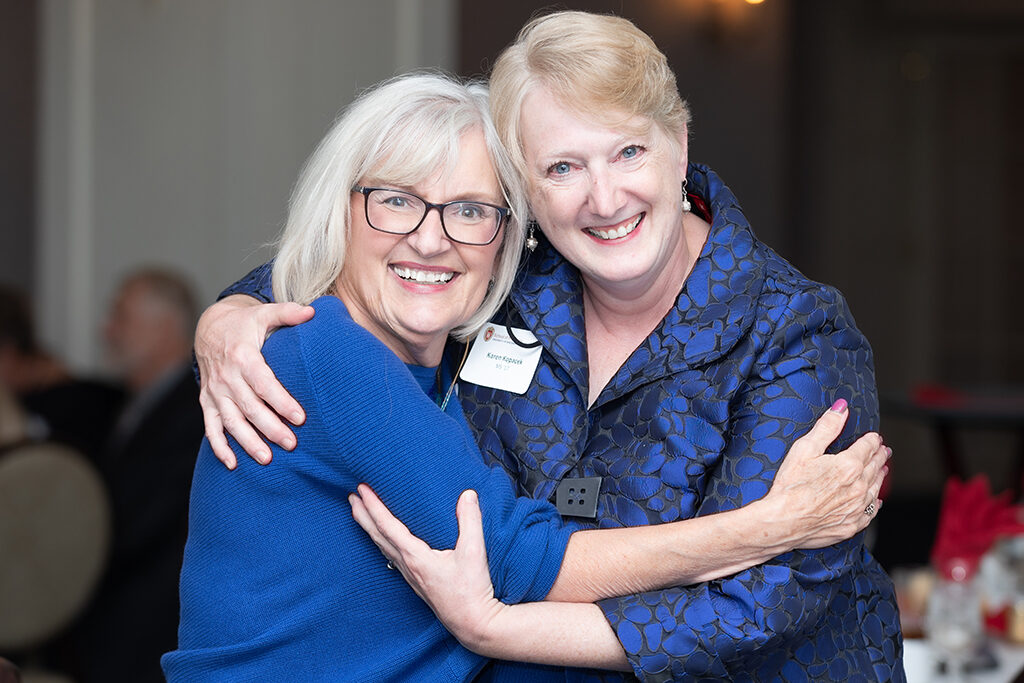 UW School of Pharmacy 2022 Citations of Merit Dinner & Awards Bonnie Fingerhut and Karen Kopacek embrace and smile.