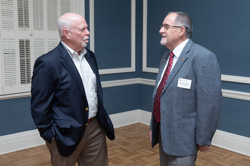 UW School of Pharmacy 2022 Citations of Merit Dinner & Awards Mel de Villiers and Bill Mellon chat.
