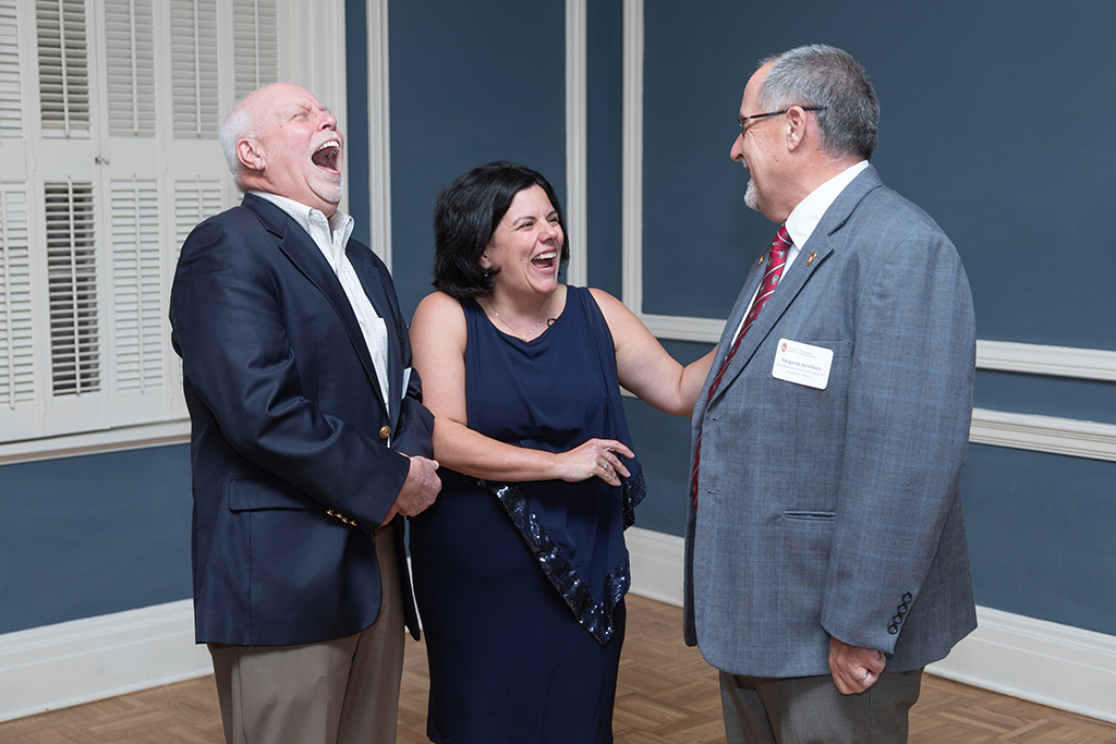 UW School of Pharmacy 2022 Citations of Merit Dinner & Awards Michelle Farrell, Mel de Villiers, and Bill Mellon laugh.