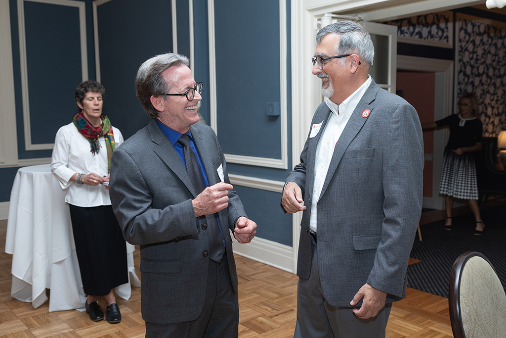 UW School of Pharmacy 2022 Citations of Merit Dinner & Awards John Swann and Greg Higby laugh together.