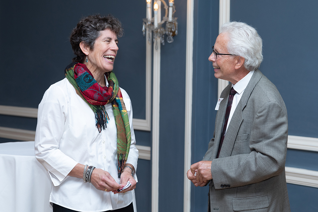 UW School of Pharmacy 2022 Citations of Merit Dinner & Awards Susan Stein smiling in conversation with Bob Breslow.