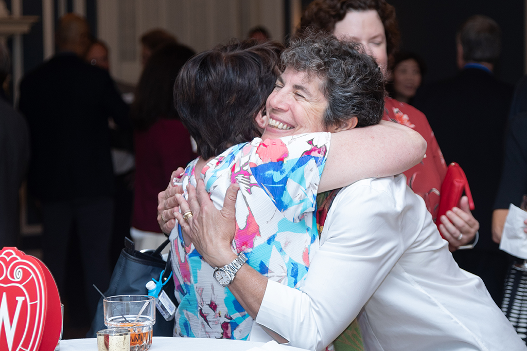 UW School of Pharmacy 2022 Citations of Merit Dinner & Awards Susan Stein and another attendee embrace.