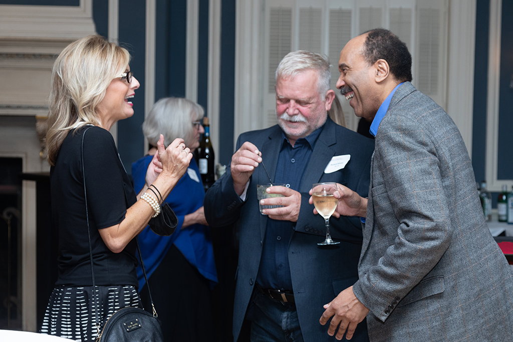 UW School of Pharmacy 2022 Citations of Merit Dinner & Awards Beth Martin speaks with Richard Kilmer and another gentleman.