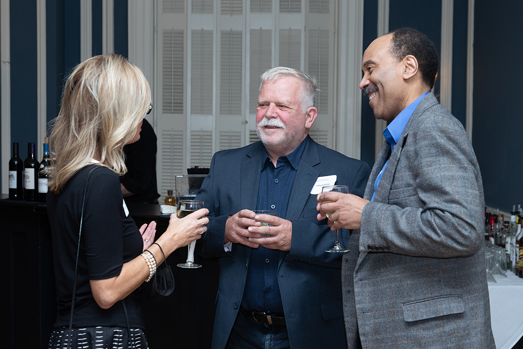 UW School of Pharmacy 2022 Citations of Merit Dinner & Awards Beth Martin speaks with Richard Kilmer and another gentleman.
