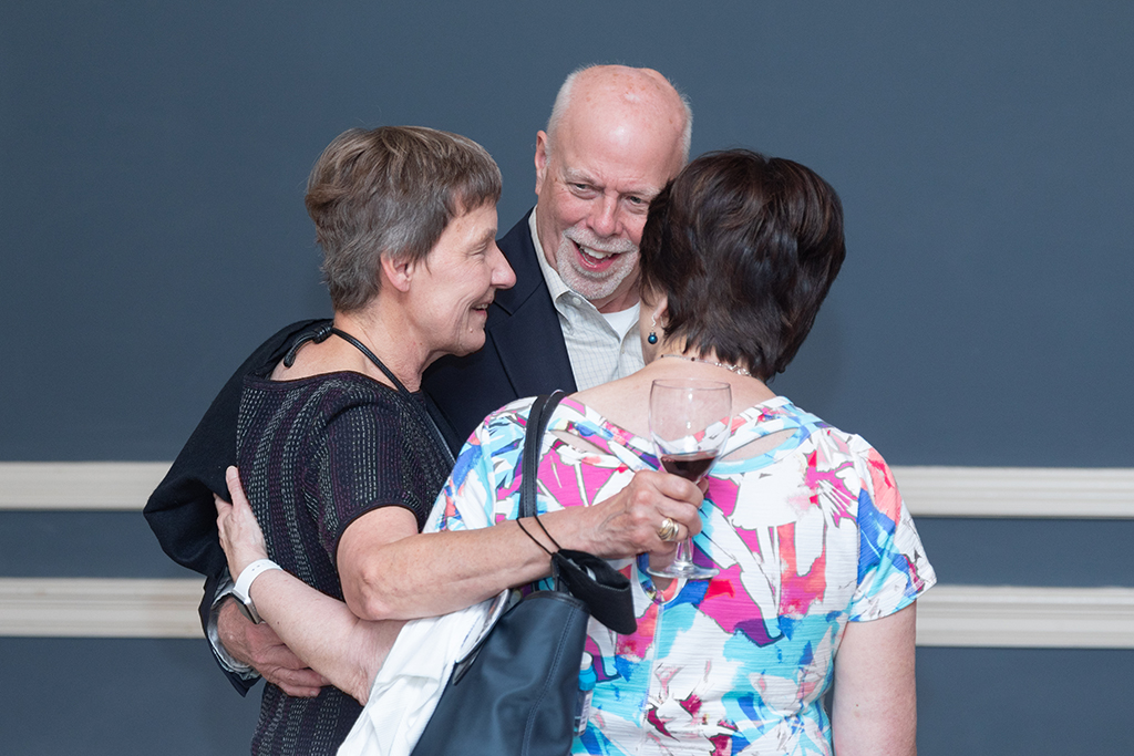 UW School of Pharmacy 2022 Citations of Merit Dinner & Awards Christine Sorkness with her arms around Bill Mellon and another attendee of the Citations of Merit.