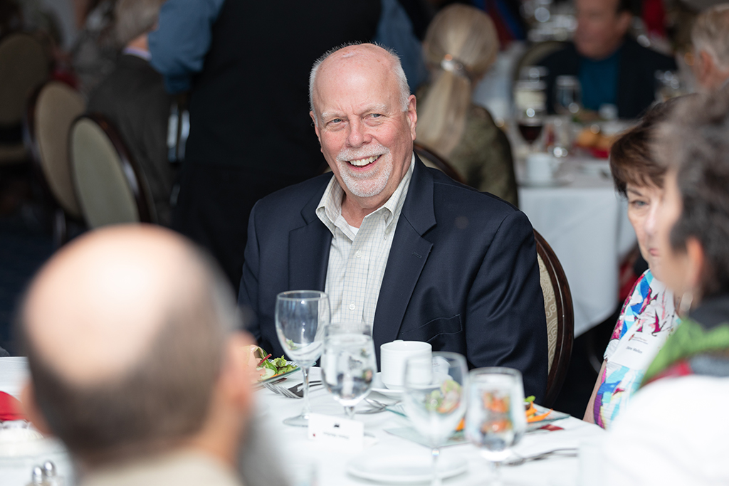 UW School of Pharmacy 2022 Citations of Merit Dinner & Awards Bill Mellon smiles while seated for dinner.