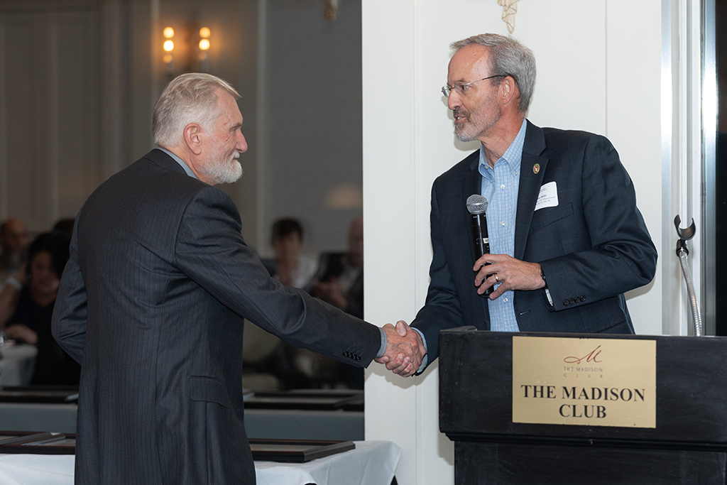 UW School of Pharmacy 2022 Citations of Merit Dinner & Awards Dave Mott and Ron Sorkness shaking hands.