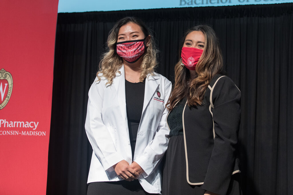 Student wearing their white coat on-stage