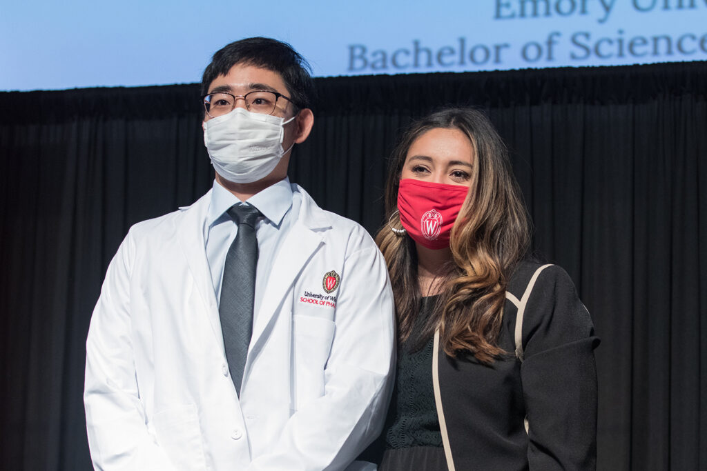Student wearing their white coat on-stage