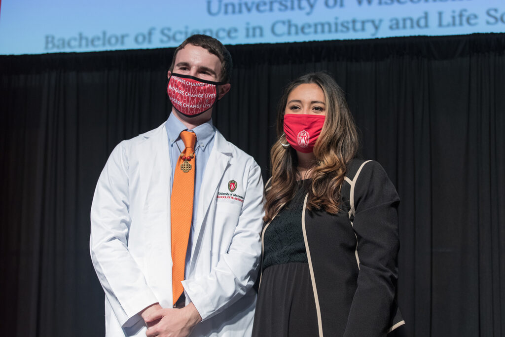 Student wearing their white coat on-stage
