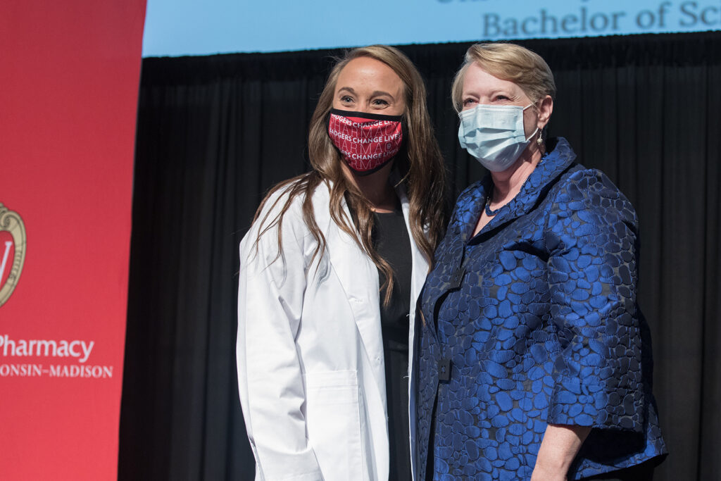 Student wearing their white coat on-stage