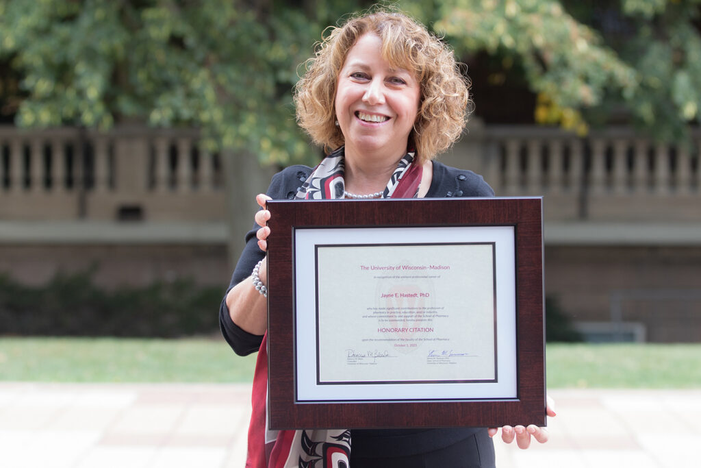 Jayne Hastedt holding her Citation of Merit award