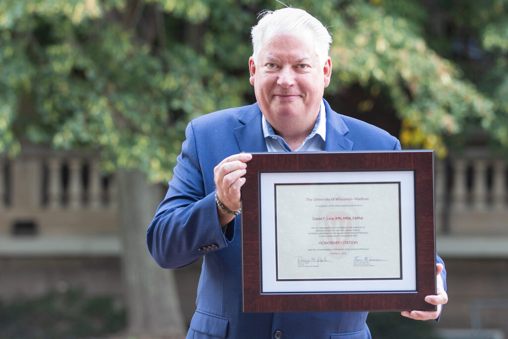 Dan Luce holding his Citation of Merit award