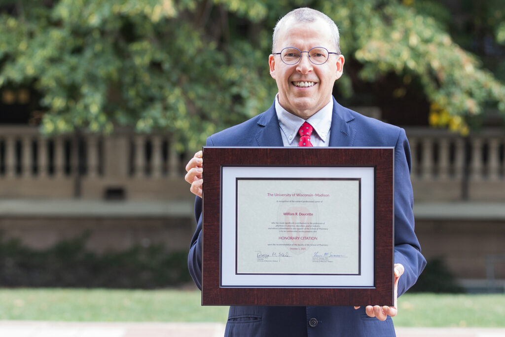 Bill Doucette holding his Citation of Merit award