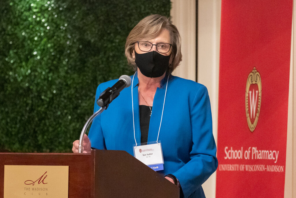 Sue Sutter speaking at the podium
