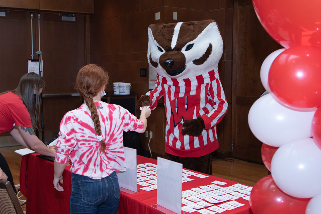 School of Pharmacy Alumni Tailgate Party 2021 Bucky handing out name tags at event