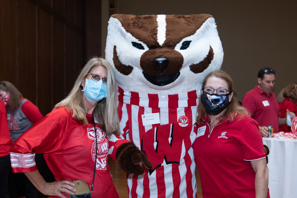 School of Pharmacy Alumni Tailgate Party 2021 Bucky with two female alumni