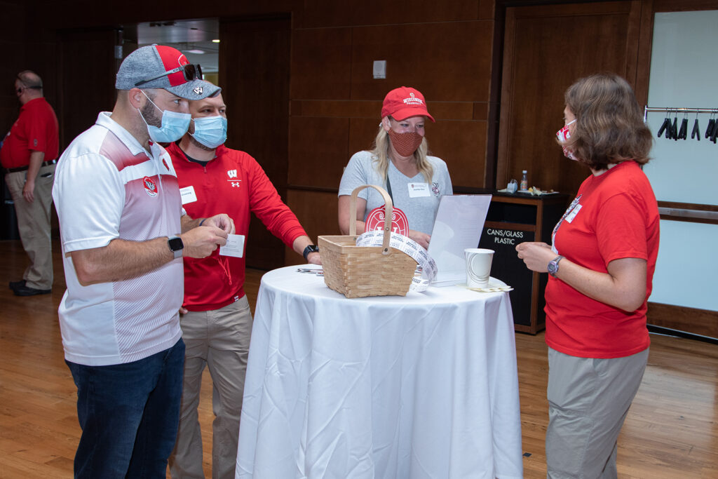 School of Pharmacy Alumni Tailgate Party 2021 Event alumni talking around table