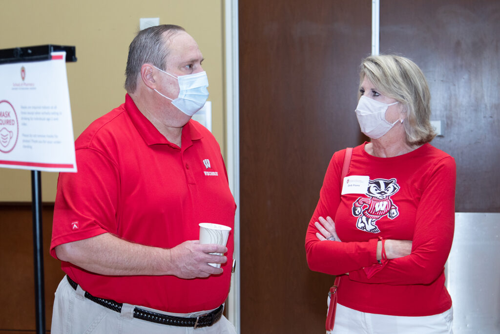 School of Pharmacy Alumni Tailgate Party 2021 Steve Swanson and Deb Fluno together wearing Wisconsin shirts