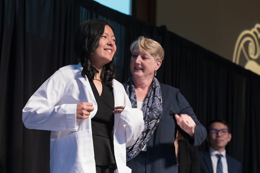 A student receives a white coat during the 2022 White Coat Ceremony.