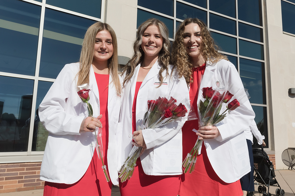 A group of students pose outside after the 2022 White Coat Ceremony.