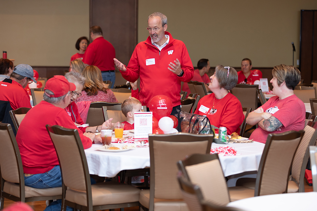 UW–Madison School of Pharmacy 2024 Alumni Tailgate and Watch Party Dave Mott speaks with Patti Thornwell and family.