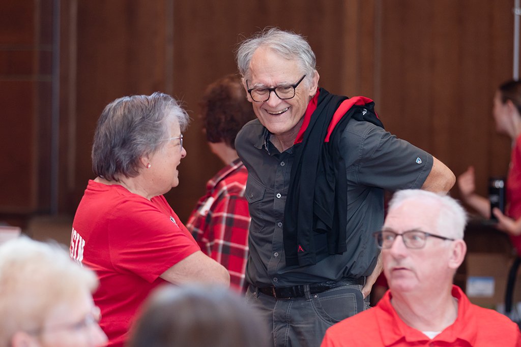 UW–Madison School of Pharmacy 2024 Alumni Tailgate and Watch Party Two alumni smile in conversation