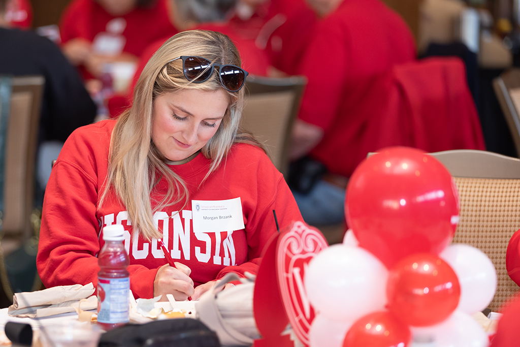 UW–Madison School of Pharmacy 2024 Alumni Tailgate and Watch Party Morgan Brzank writes something with a pen