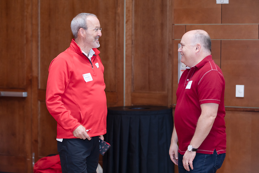 UW–Madison School of Pharmacy 2024 Alumni Tailgate and Watch Party Dave Mott smiles during an animated conversation with an attendee