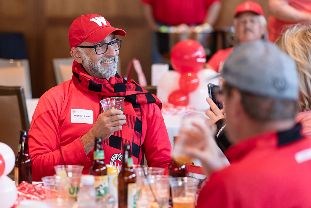 UW–Madison School of Pharmacy 2024 Alumni Tailgate and Watch Party Michael Gallo smiles while holding his drink