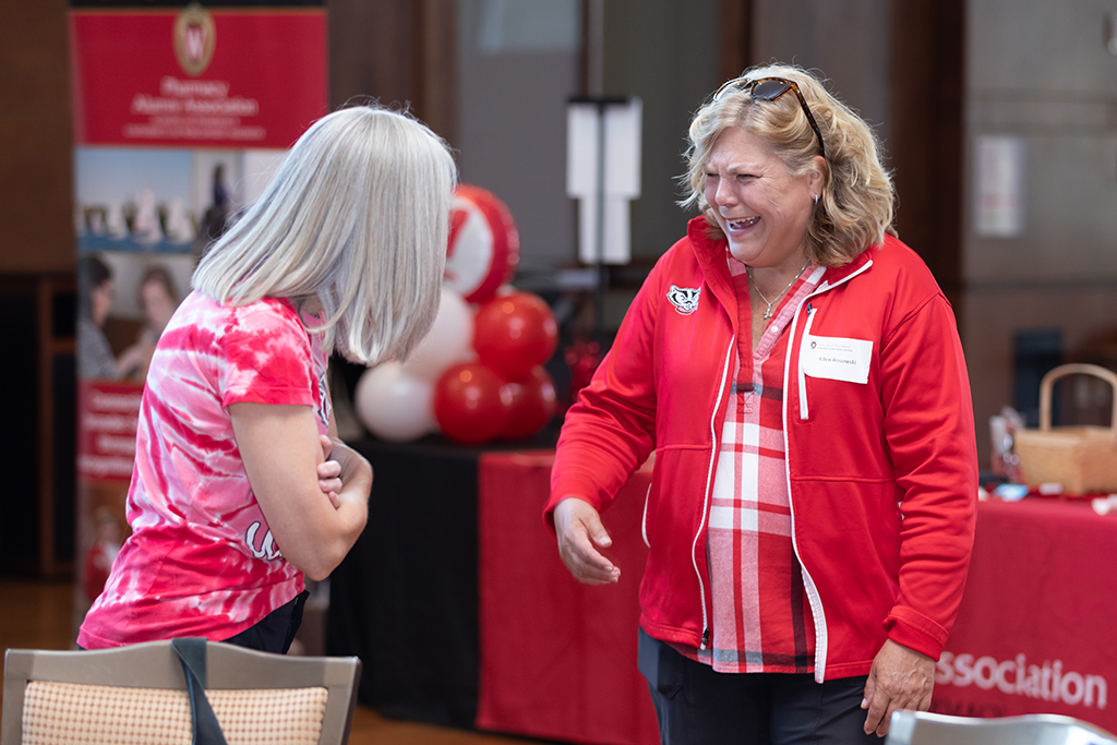 UW–Madison School of Pharmacy 2024 Alumni Tailgate and Watch Party Ellen Rosowksi laughs with another attendee